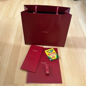Cartier shopping bag, receipt holder, perfume samples and coloring book